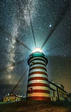 Lighthouse at night at harbor in Lubec, Maine. Photo by Reena Walking.